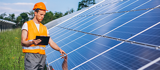 A technician checking on the installed solar panels